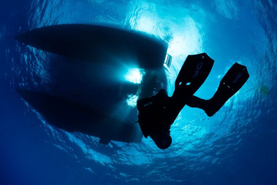 Diver underneath a Catamaran Diver underneath a Catamaran